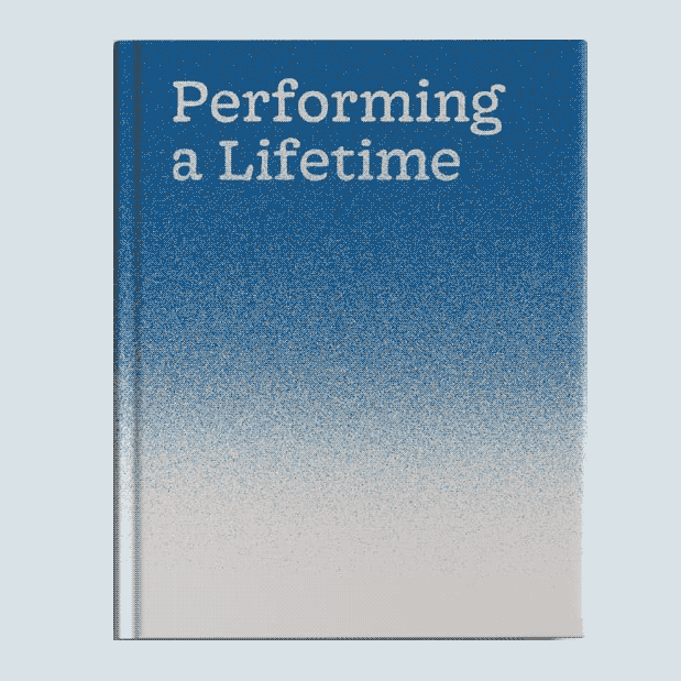 A white and blue book cover with a text that reads 'performing a lifetime'